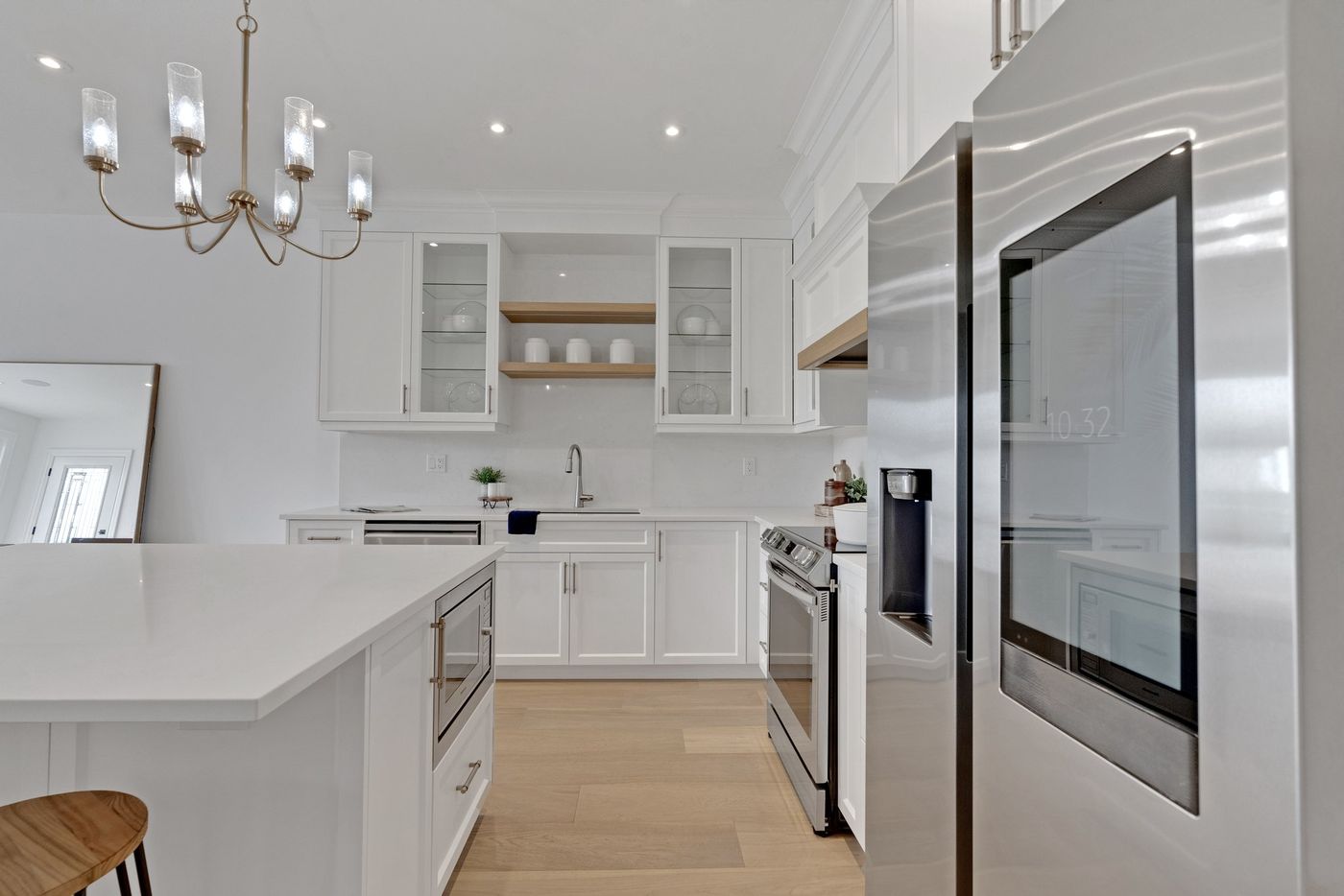 Kitchen with glass-front cabinets and stainless appliances