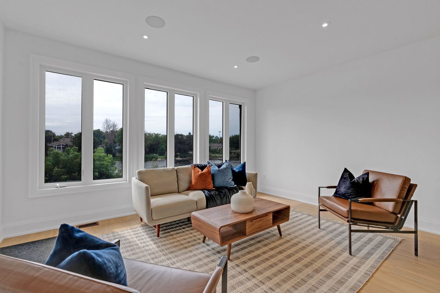 Living room with water views through tall windows