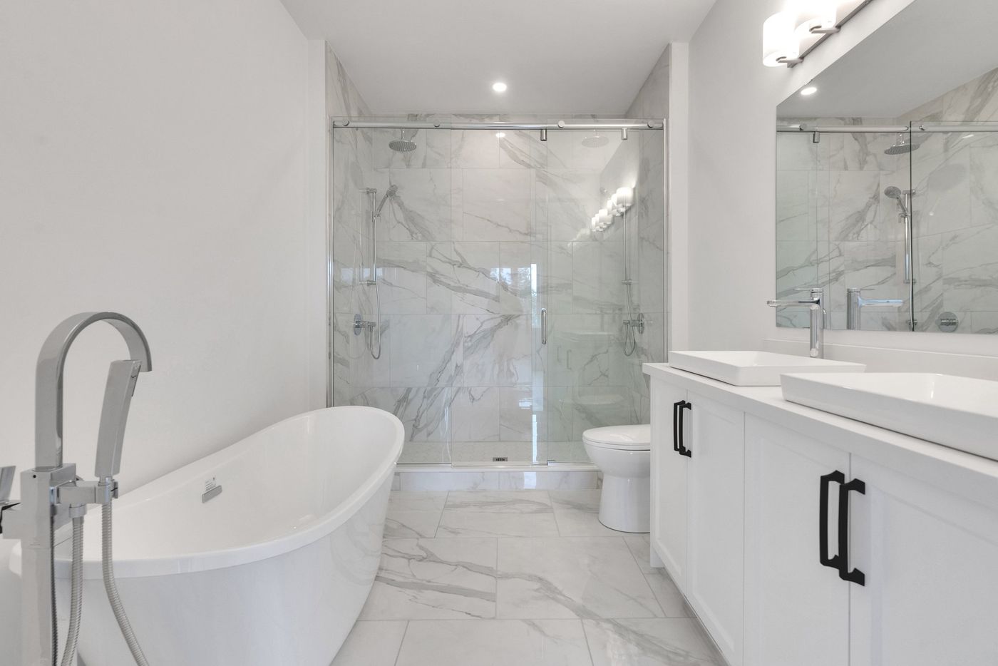 Primary ensuite with freestanding tub and double shower